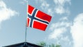 The norwegian flag against blue sky Royalty Free Stock Photo