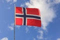 The norwegian flag against blue sky Royalty Free Stock Photo