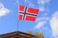 The norwegian flag against blue sky Royalty Free Stock Photo