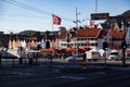 Norwegian flag along the wood historical buildings and other buildings in downtown Bergen, Norway