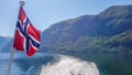 Norway - Norwegian flag waving above the water. Royalty Free Stock Photo