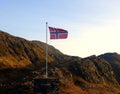 Norwegian flag on top of a mountain in Bergen city
