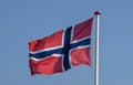 Norwegian flag waving against blue sky Royalty Free Stock Photo