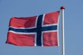 Norwegian flag waving against blue sky Royalty Free Stock Photo