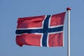 Norwegian flag waving against blue sky Royalty Free Stock Photo