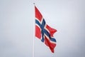 Norwegian flag waving on blue clear sky background Royalty Free Stock Photo