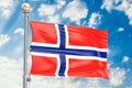 Norwegian flag waving in blue cloudy sky, 3D rendering Royalty Free Stock Photo