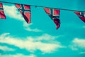 Norwegian flags against blue sky