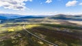 Norwegian landscape view with road, mountains and blue sky,aerial shot from drone Royalty Free Stock Photo