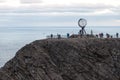 Norwegian north cape monument, with people tourists making pictures, norway, europe