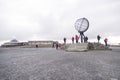 Norwegian north cape monument, with people tourists making pictures, norway, europe