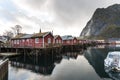 Norwegian old city Reine with reflections in water and cloudy sk