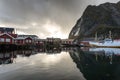 Norwegian old city Reine with reflections in water and cloudy sk