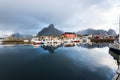 Norwegian old city Reine with reflections in water and cloudy sk Royalty Free Stock Photo