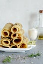 Norwegian potato pancakes Lefse on a light background with cheese and greens.