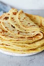 Norwegian potato pancakes Lefse on a light background with cheese and greens. Scandinavian cuisine.