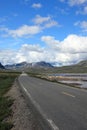 Empty mountain road landscape Norway mountains summer blue sky clouds travel highway rural country nature asphalt green beautiful Royalty Free Stock Photo