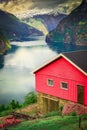 Norwegian rorbu above Aurlandsfjord with reflection and boat, Norway , Nordic