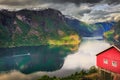 Norwegian rorbu above Aurlandsfjord with reflection and boat, Norway , Nordic