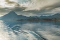 Norwegian seascape, lighthouse on the island, rocky coast with dramatic skies, the sun breaks through the clouds, sheer