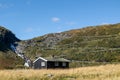 Norwegian traditional black house on serpentine mountain road