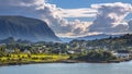 Norwegian village in fjord landscape on sunny day Royalty Free Stock Photo