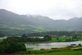 Norwegian village landscape with fjord, high mountains and colorful houses in Olden, Norway Royalty Free Stock Photo