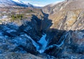 Norwegian Voringfossen waterfall in early spring, leftover ice left over from winter in the Bjoreio valley in the Eidfjord Royalty Free Stock Photo