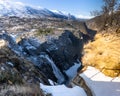 Norwegian Voringfossen waterfall in early spring, leftover ice left over from winter in the Bjoreio valley in the Eidfjord Royalty Free Stock Photo
