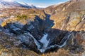 Norwegian Voringfossen waterfall in early spring, leftover ice left over from winter in the Mabodalen valley in the Eidfjord Royalty Free Stock Photo