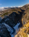 Norwegian Voringfossen waterfall in early spring, leftover ice left over from winter in the Mabodalen valley in the Eidfjord Royalty Free Stock Photo