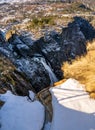 Norwegian Voringfossen waterfall in early spring, leftover ice left over from winter in the Mabodalen valley in the Eidfjord Royalty Free Stock Photo