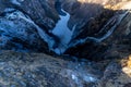 Norwegian Voringfossen waterfall in early spring, leftover ice left over from winter in the Mabodalen valley in the Eidfjord Royalty Free Stock Photo