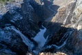 Norwegian Voringfossen waterfall in early spring, leftover ice left over from winter in the Mabodalen valley in the Eidfjord Royalty Free Stock Photo