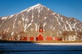 Norwegian wooden red church before mountain Royalty Free Stock Photo