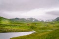 Norwegian wooden summer house overlooking scenic lake, Norway, Scandinavia. Cottage By Lake In Rural. Peat roofed hut on Lake. Royalty Free Stock Photo