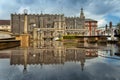 Norwich guildhall reflecting in rain water puddle