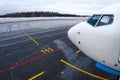 Nose and cockpit of the aircraft, a view of the parking lot and steering track to the runway at the airport Royalty Free Stock Photo