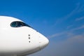 Nose and cockpit of pilots aircraft on a background of blue clear sky Royalty Free Stock Photo