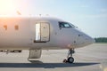 Nose and cockpit of a white passenger jet in the airport parking lot. Passenger aircraft, white airplane without livery Royalty Free Stock Photo