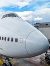 Nose of a large white aircraft at an airport Royalty Free Stock Photo