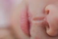 Nose and lips of a newborn close up. Baby face features macro photo. Blurred image Royalty Free Stock Photo