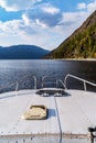 The nose of a motor boat sailing on a mountain lake. View from the cockpit right on course. Fall