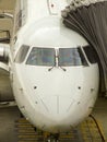 Nose of narrow body passenger aircraft connected to the trap. Royalty Free Stock Photo