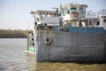 Nose of wrecked boat in a winter day at river coastline. Side view. Royalty Free Stock Photo