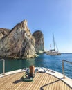 Nose of a yacht boat aimed at cliffs in the Aegean sea. Santorini, Greece Royalty Free Stock Photo