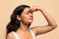 Nosebleeds concept. Young indian woman with closed eyes touching nose bridge Royalty Free Stock Photo