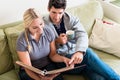 Nostalgic couple smiling while looking at a photo album together