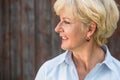 Nostalgic senior woman looking away with a smile while daydreami Royalty Free Stock Photo