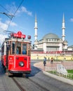 Nostalgic Taksim Tunel Red Tram, or tramvay, with Taksim Mosque in the background, at Taksim Square, Istanbul, Turkey Royalty Free Stock Photo